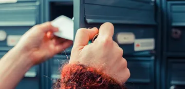 <p>Closeup on a woman’s hand as she is getting her post out of her letterbox</p>
